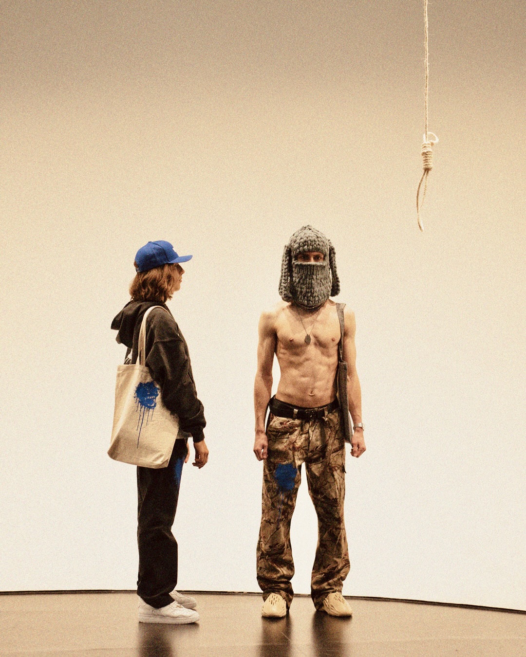 Two Models wearing a ZIP-HOODIE, CAMO PANTS, TOTE BAG, and other pieces from the WILD BECT collection by BECT.